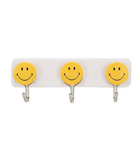 Colorful smiley face hooks for decorative wall hanging.