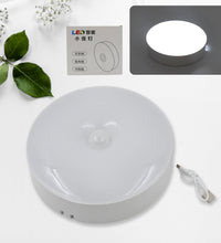 LED light with motion sensor, round shape, 8 LEDs, energy-efficient.