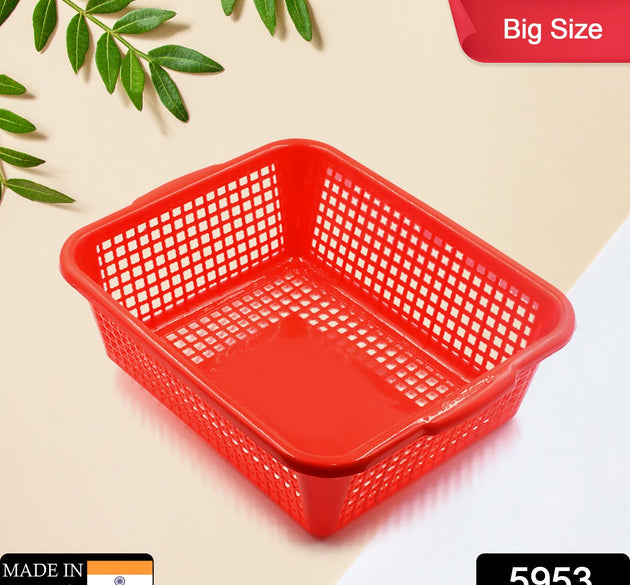 Rectangular plastic drain basket for washing fruits and vegetables in the kitchen sink.