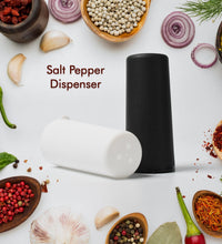 Salt and pepper dispensers on table