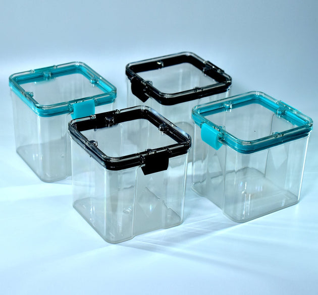 Set of four 700ml square containers, ideal for storing various food items.