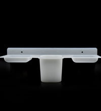 Plastic soap dish and tray with functional design for efficient soap storage.