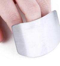 Stainless steel finger guard for safe cutting in kitchen.