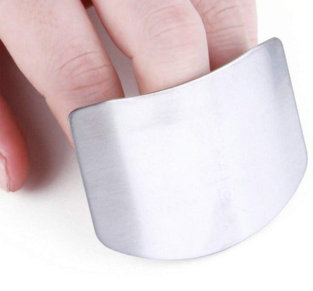 Stainless steel finger guard for safe cutting in kitchen.