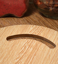 Small round wooden chopping board