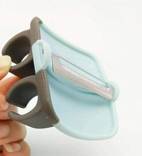 Hand palm vegetable peeler with rubber grip.