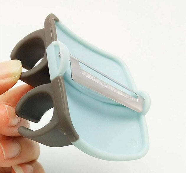 Palm-held vegetable peeler with a rubber finger grip.