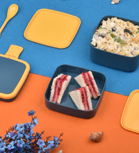 Blue lunch box with handle and spoon for meals