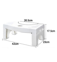 White plastic squat stool with secure non-slip feet for toilets.