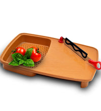 Versatile kitchen chopping tray with built-in holder.