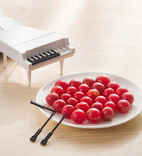 Cute piano-style fruit forks for fun snacking.