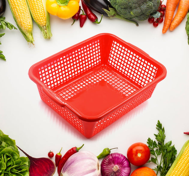 Rectangular plastic drain basket for washing fruits and vegetables in the kitchen sink.