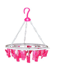 Round drying stand with 24 multicolour clips for hanging clothes.