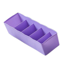 Clear plastic organizer tray with multiple compartments for bead storage.