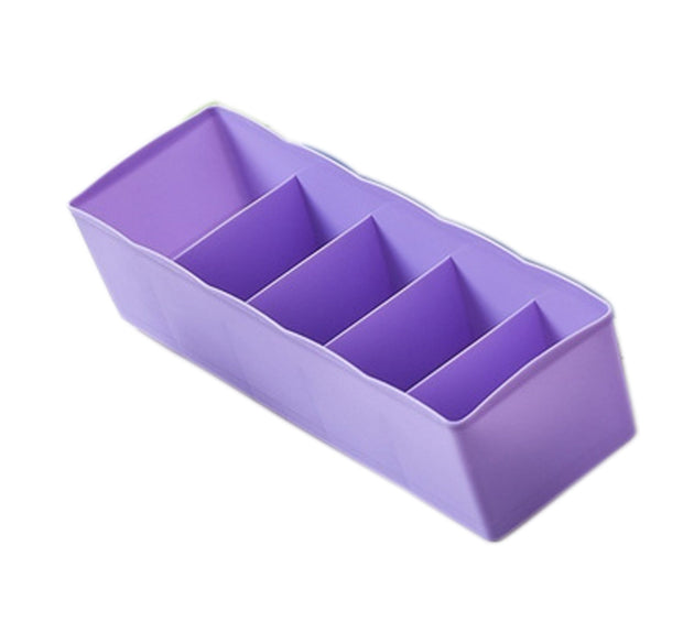 Clear plastic organizer tray with multiple compartments for bead storage.