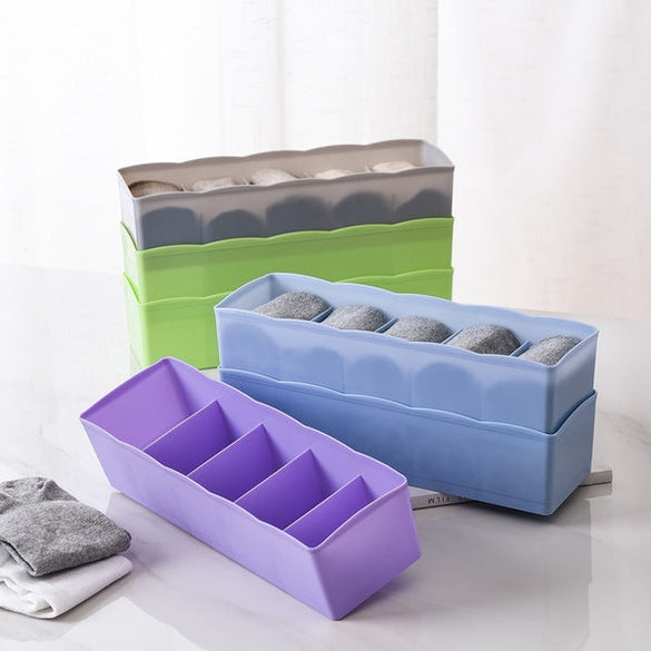 Clear plastic organizer tray with multiple compartments for bead storage.