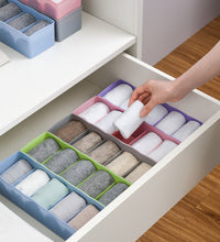 Clear plastic bead storage tray with multiple compartments for easy organization.