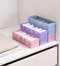 Organizer tray with clear plastic and several compartments for bead storage.