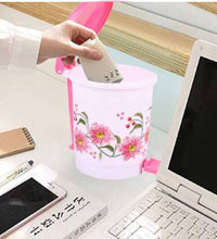 Small plastic pedal dustbin for home or office, easy hands-free use.