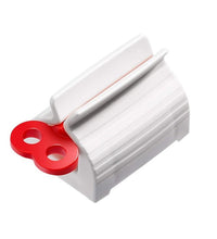 Stand and squeezer for rolling toothpaste tubes