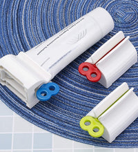 Stand for toothpaste tubes with built-in squeezer