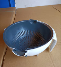 Kitchen bowl and strainer with handle for washing and draining produce.