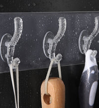 Transparent adhesive wall hook mounted on a surface