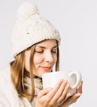 Warm winter cap with black knitted exterior and fur lining