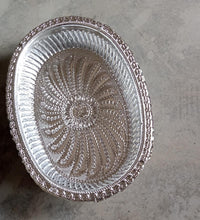 Multipurpose oval silver tray with a royal pattern for various uses.