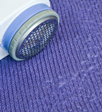 Detailed image of the lint remover, highlighting its design for removing lint from woolens