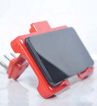 Wall-mounted mobile charging holder in red.