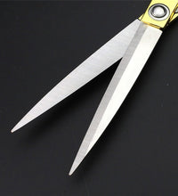 Professional gold-plated scissors for precise fabric cutting.