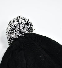 Woolen knitted beanie cap with skull pattern.