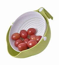 Washing bowl with strainer and handle for efficient fruit and vegetable cleaning.