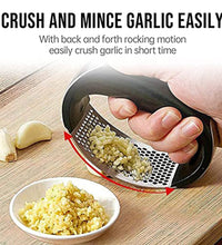 Garlic press in use