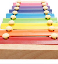 Wooden xylophone with colorful bars and mallet, suitable for children