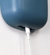 Wall-mounted charging holder.