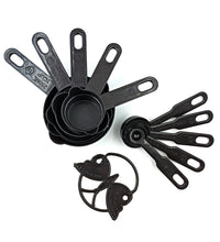 Set of black plastic measuring cups and spoons, featuring a butterfly-shaped holder for organization