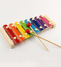 Xylophone with mallet on a white background, highlighting the wooden design