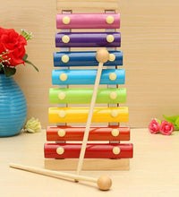 Multicolored wooden xylophone with mallet displayed on a surface