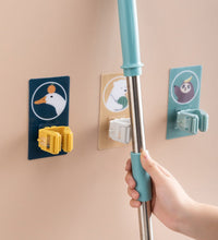 Self-adhesive wall mount for holding mops and brooms securely.