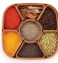 Multi-compartment masala box for organizing spices and herbs.