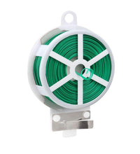 Green garden wire spool with cutter for securing plants.