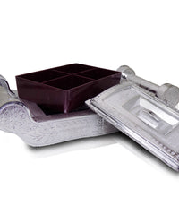 Decorative silver storage box with four sections for organizing.