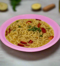 Round mini soup plates arranged on a surface.