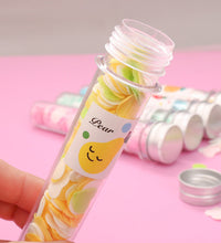 Test tube containing flower-shaped paper soap strips for travel.