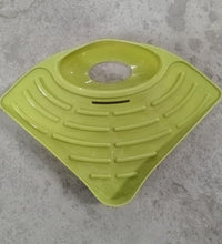 Corner sink strainer basket, triangular drain shelf for kitchen organization.