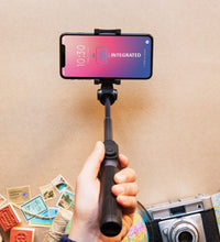 Folded selfie stick with phone holder and Bluetooth remote