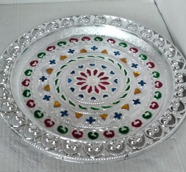 Silver plated pooja thali for religious ceremonies.