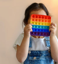 Detailed view of the rainbow-colored fidget toy, emphasizing its unique shape and vibrant colors